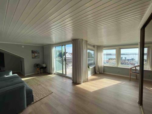 a living room with a couch and large windows at Villa with spectacular sea view in Öckerö