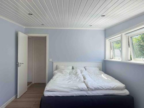 a bed in a room with a window at Villa with spectacular sea view in Öckerö