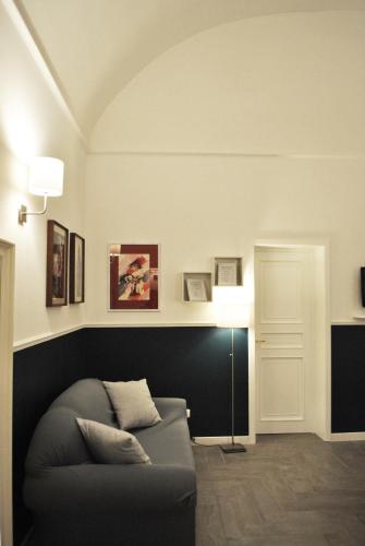 a living room with a couch and a lamp at Novecento Dimore di Poesia in Trani