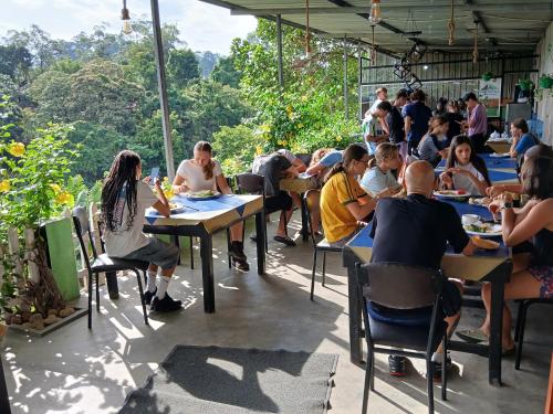 a group of people sitting at tables in a restaurant at Green Peak - Mountain View Hotel & Restaurant in Ella