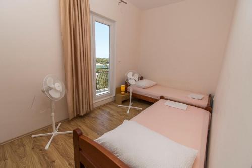 a small room with a bed and a window at Apartment Mila in Dolac