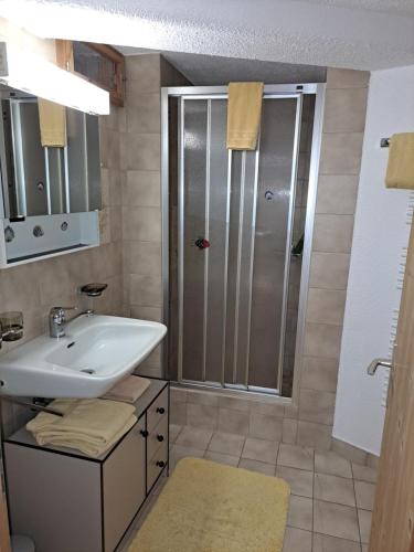 a bathroom with a sink and a shower at Berggasthaus Gemsli in Sankt Antönien