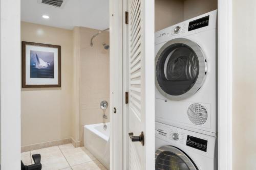 a bathroom with a washer and dryer at Honua Kai Konea 230 in Kahana