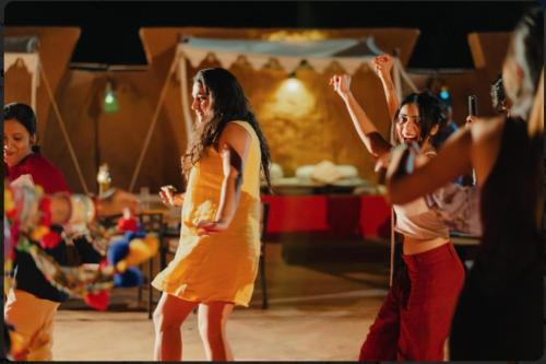 a group of girls dancing on a dance floor at Sam Desert Luxury Resort in Sām