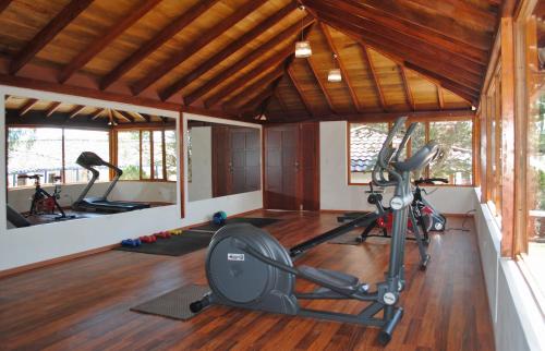 a gym with exercise equipment in a room at Hacienda Hosteria Chorlavi in Ibarra