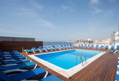 a swimming pool on the deck of a cruise ship at Hotel Voramar in Benidorm