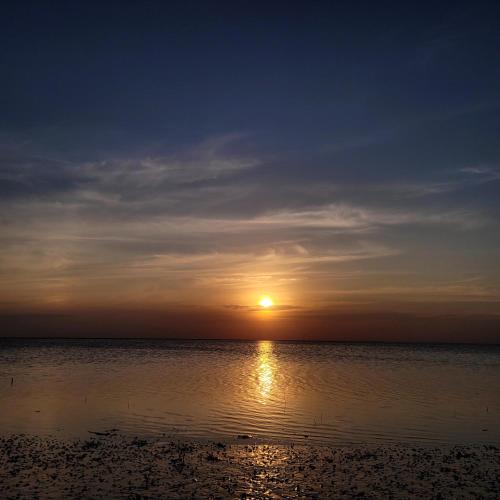 a sunset on the beach with the sun setting at The Sanctum in Talaimannar
