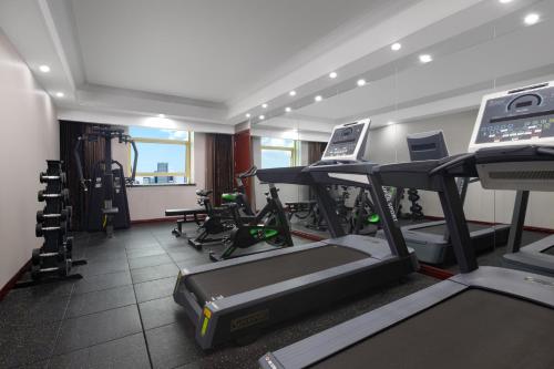 a gym with treadmills and machines in a room at Days Hotel & Suites China Town---Five minutes to reach Changsha Station, the metro Line 2 & Line 6 are nearby,free gym & laundromat,Chinese and Western buffet breakfast is offered on the 31st floor in Changsha