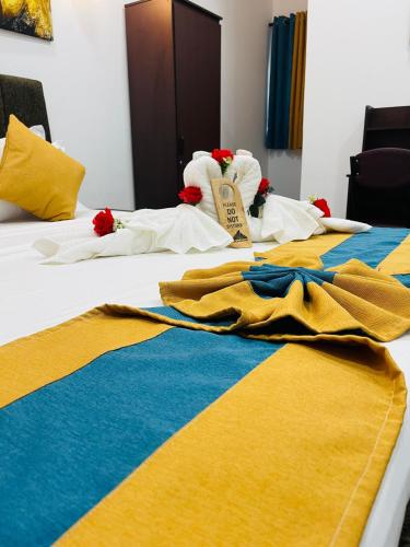 a couple of beds with towels on them at The Sanctum in Talaimannar