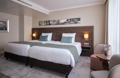 a bedroom with a large bed in a hotel room at Leonardo Royal Hotel Düsseldorf Königsallee in Düsseldorf