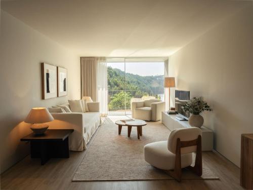 a living room with a couch and a table at Octant Douro in Castelo de Paiva
