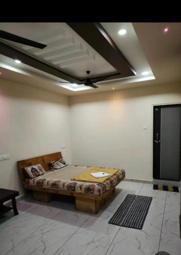 a bedroom with a bed in a room with a ceiling at Hotels shivtej lodging in Top