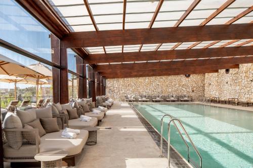 a swimming pool with lounge chairs and a swimming pool at Daroma by Isrotel Collection in Mitzpe Ramon