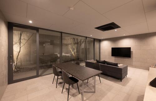 a living room with a table and a couch at Villa Reine in Beppu