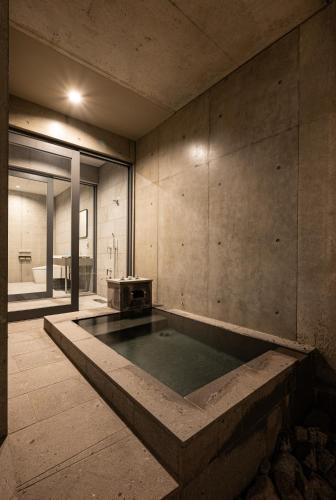 a swimming pool in the middle of a room at Villa Reine in Beppu