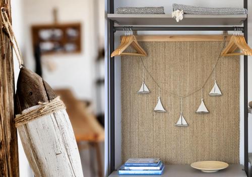 a shelf with a wall with someones kitchen utensils at LA GUARDIA Hotel in Giglio Porto