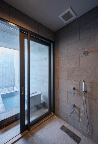 a bathroom with a shower and a bath tub at Villa Reine in Beppu