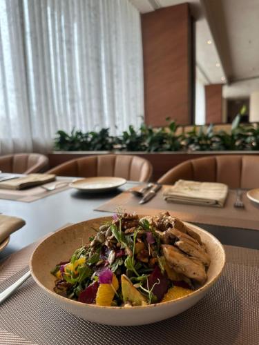 a plate of food on a table with a salad at Park Plaza Chandigarh Zirakpur in Chandīgarh