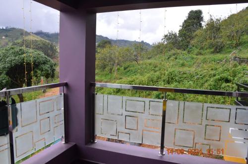a balcony with a view of a mountain at Siesta Inn- Mountain View in Kodaikānāl