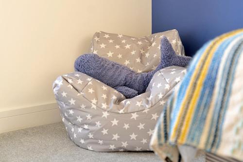 a gray and white chair with purple pillows in a room at Finest Retreats - Firethorn in Bude