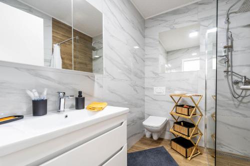 a bathroom with a white sink and a shower at Apartment Midi in Vir