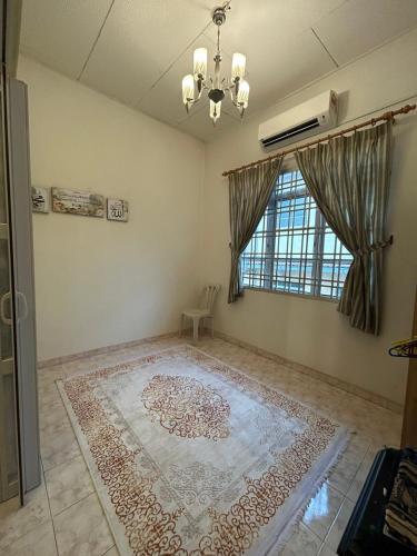 a living room with a rug on the floor and a window at Casa D' Bernam in TanjongMalim