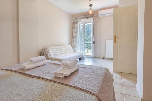 a bedroom with a bed with towels on it at Nikos and Vicky's House in Kefalonia