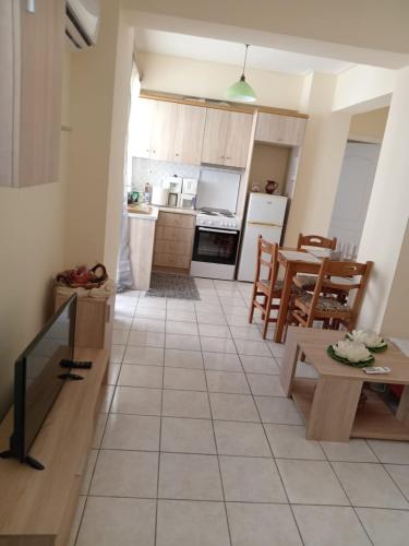 a kitchen and dining room with a table and chairs at DIMHA Studio in Pýrgos