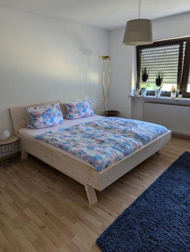 a bedroom with a bed with a blue comforter at Ferienwohnung Sperber in Windischeschenbach