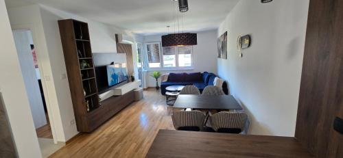 a living room with a table and a couch at Apartment Lazarus with garage Banja Luka in Banja Luka