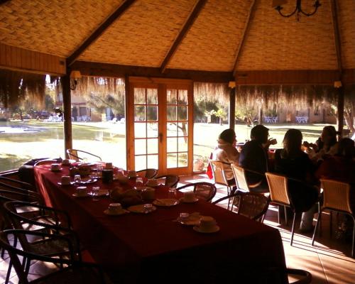 a group of people sitting at a table in a restaurant at Stellamar Apart Hotel in La Serena