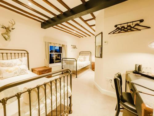 a bedroom with two bunk beds in a room at The Powell Birchington, Boutique Rooms in Birchington