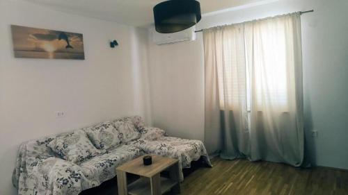 a living room with a couch and a table at House Solis in Banjol