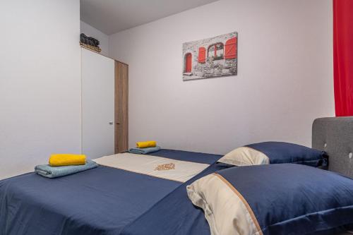 a bedroom with two twin beds with blue sheets at House Nina in Pazin
