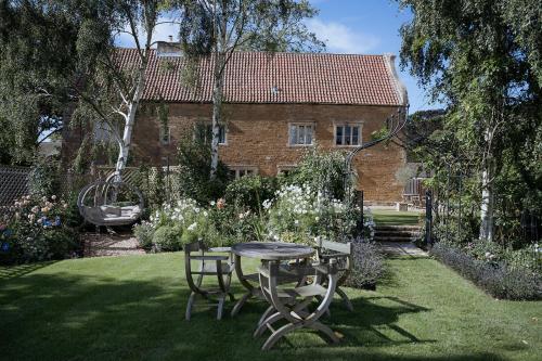 a table and chairs in the yard of a house at Allington Manor in Allington