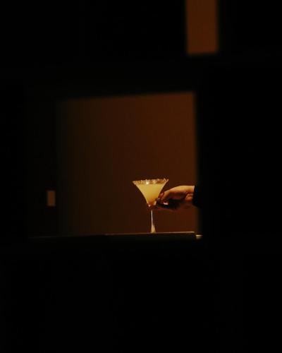 a person holding a martini glass in a dark room at Park Plaza Chandigarh Zirakpur in Chandīgarh