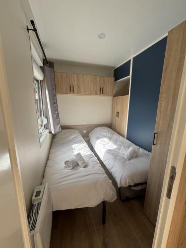 a small room with two beds in it at Camping VVF Le Kerostin in Pontivy