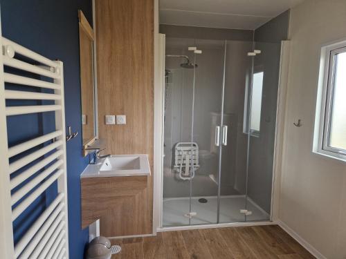 a bathroom with a shower and a sink at Camping VVF Pontivy in Pontivy