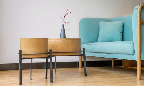 a table and chair next to a blue couch at Chen Jia Garden Hotel in Xingping