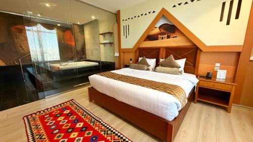 a bedroom with a large bed and a bath tub at Holiday Villa Hail in Hail