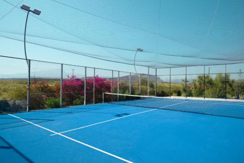 a tennis court with a net on top of it at Iberostar Waves Creta Panorama & Mare in Panormos Rethymno