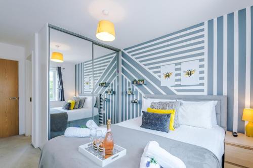 a bedroom with two beds with blue and white stripes at Stunning Riverside 3-Bed Home by 53 Degrees Property in Manchester with Garden & FREE Parking! in Manchester