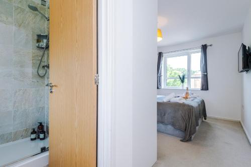 a bathroom with a bed and a window and a shower at Stunning Riverside 3-Bed Home by 53 Degrees Property in Manchester with Garden & FREE Parking! in Manchester