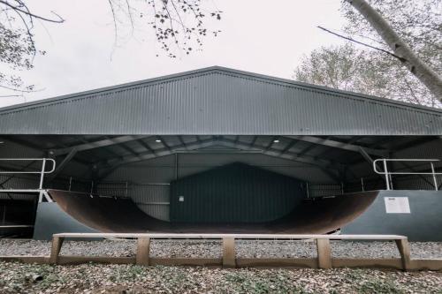 a large building with a large metal roof at Rooke River Lodge in Jindabyne
