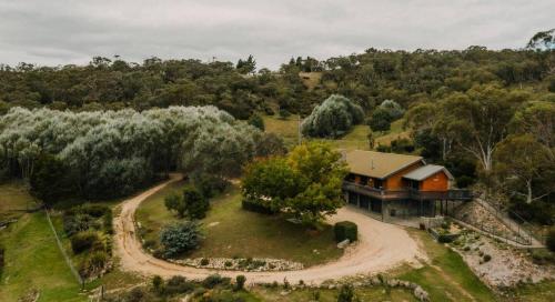 an aerial view of a house on a hill at Rooke River Lodge in Jindabyne