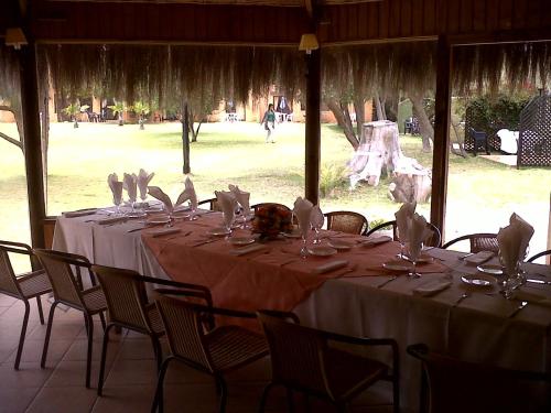 a long table with white tablecloths and napkins on it at Stellamar Apart Hotel in La Serena