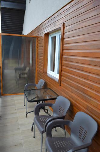 a room with chairs and tables and a window at Apartmani Srećko in Žabljak