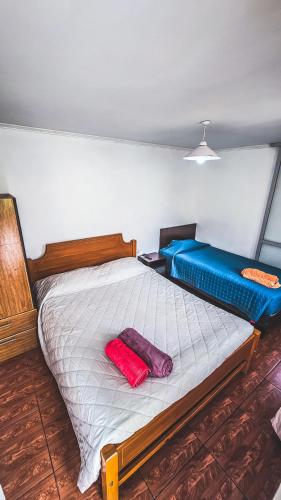 a bedroom with a bed with two pillows on it at Kunturi in Arica