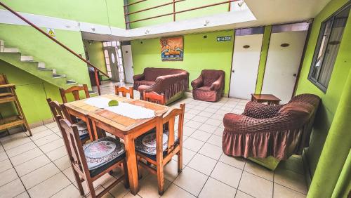 a room with a table and chairs and stairs at Kunturi in Arica