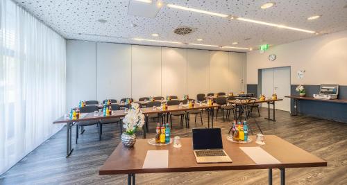 a conference room with tables and chairs with laptops at Best Western Plaza Hotel Zwickau in Zwickau